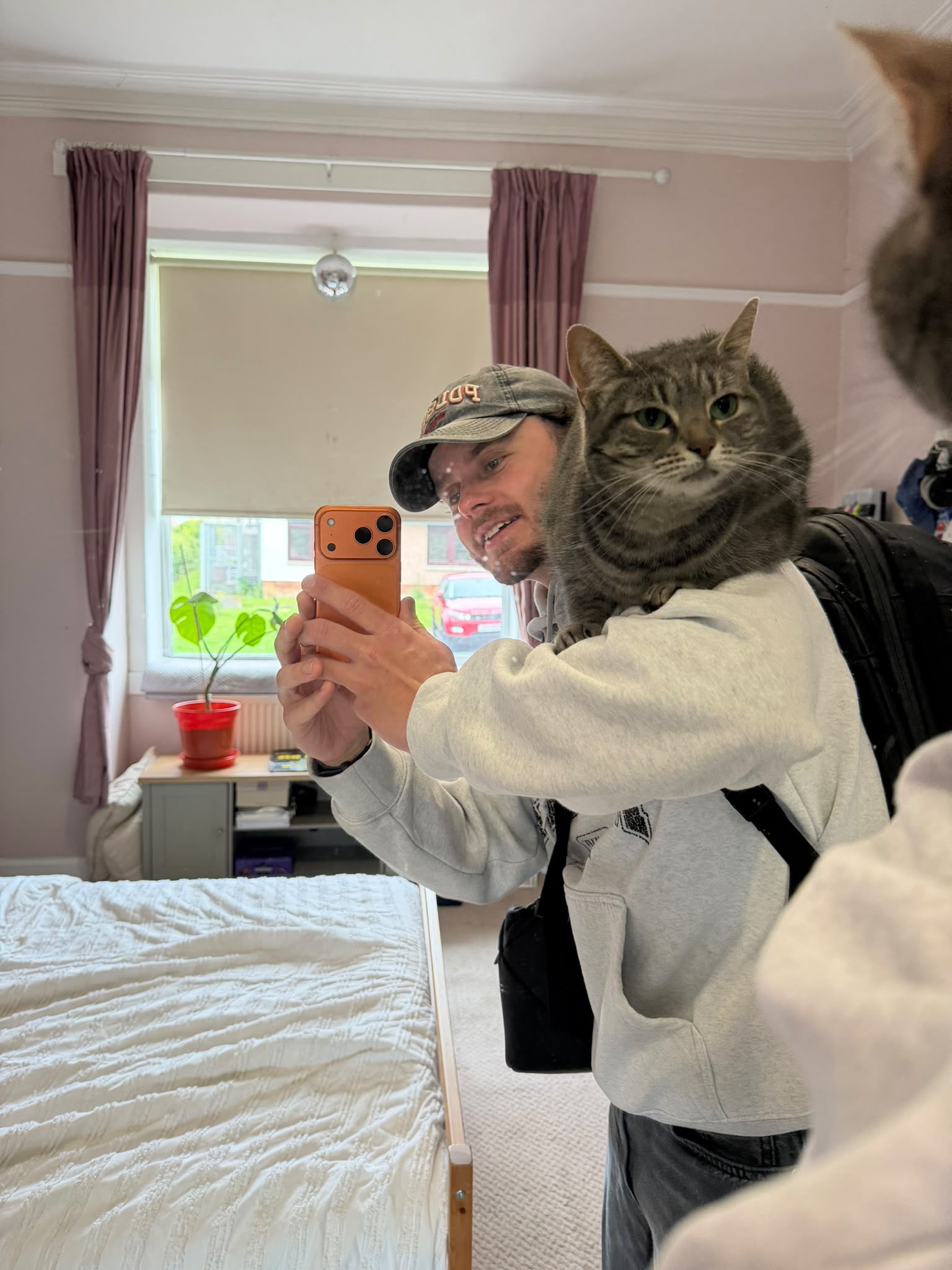 Calum with Arya the cat on his shoulder