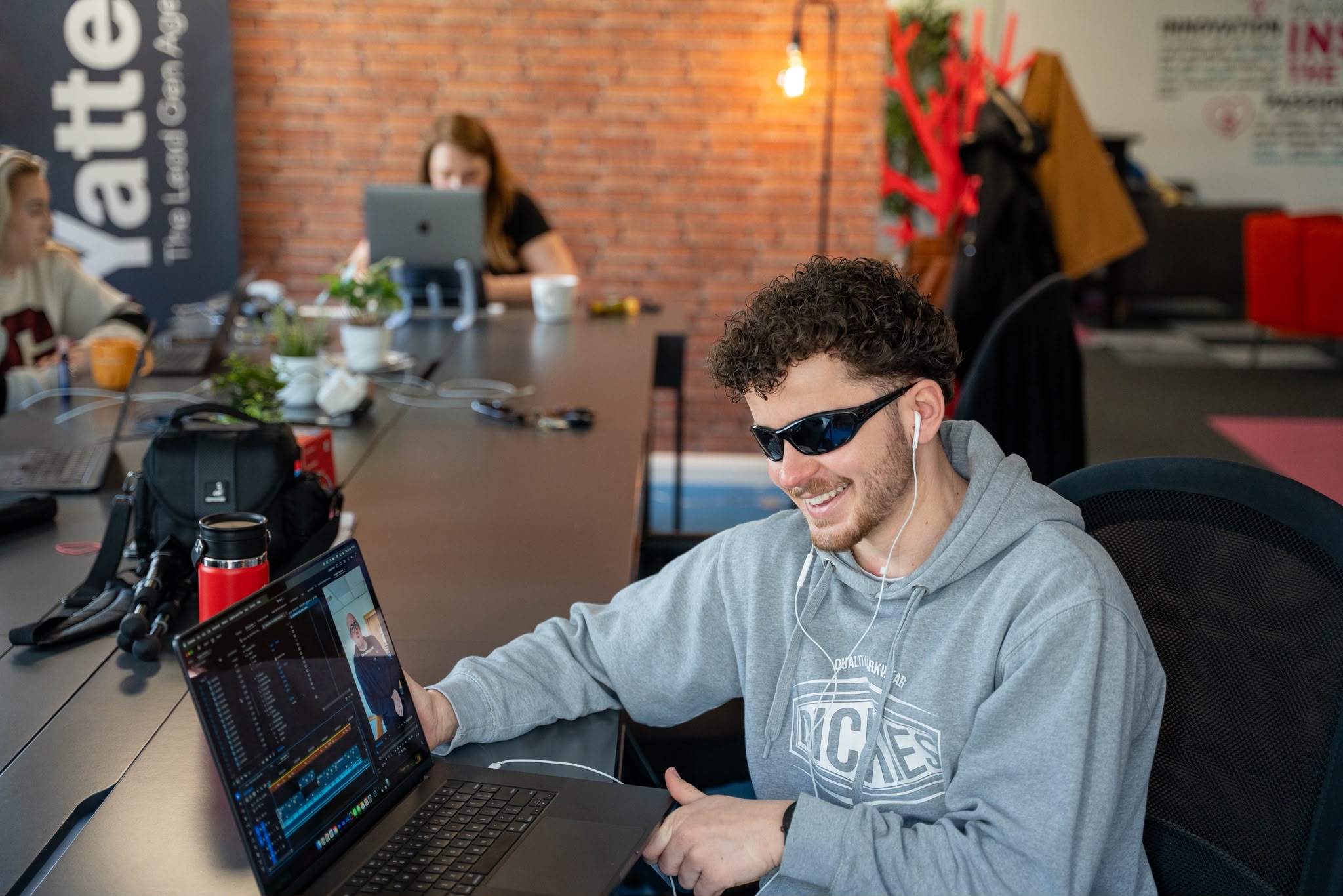 Calum editing footage on a laptop